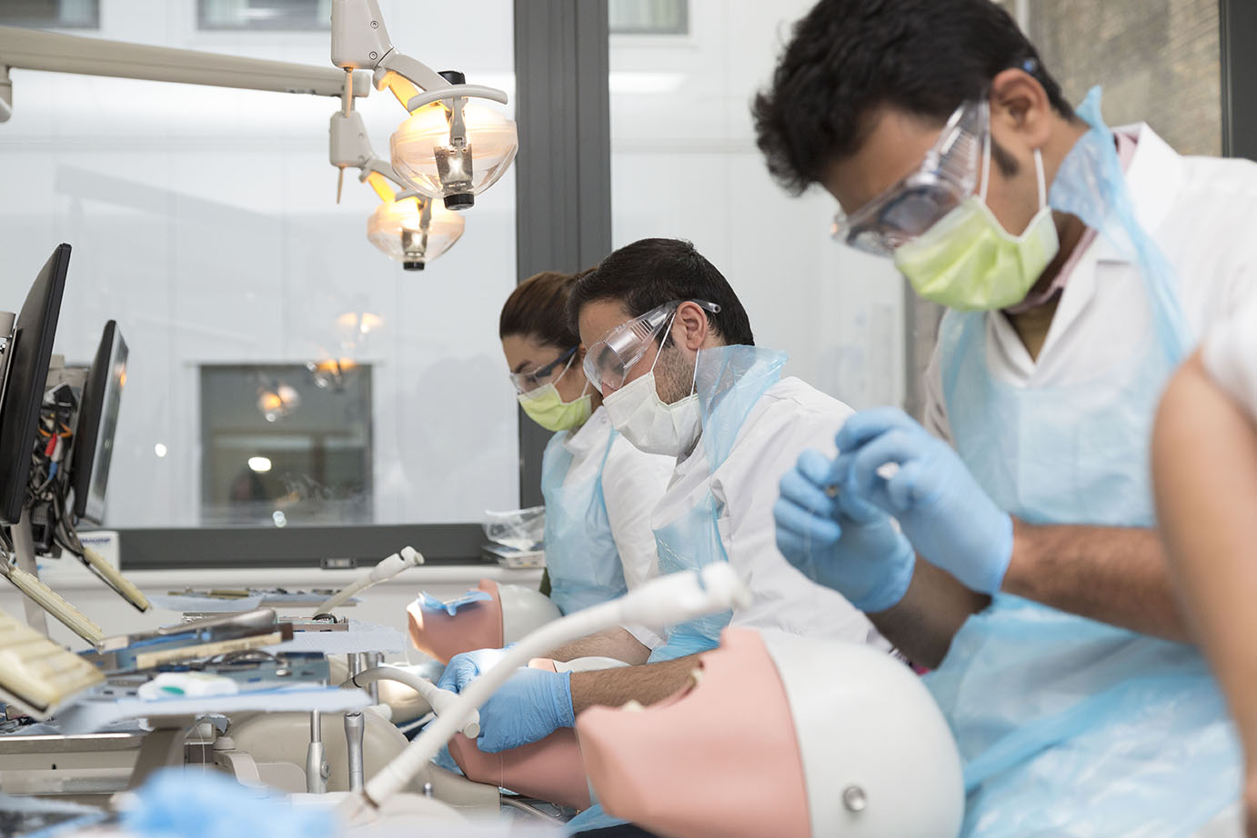 Dentistry students training using a simulation dummy