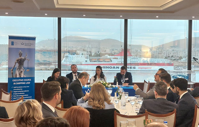 Professor Miriam Goldby and Dr Filip Saranovic on a panel in the  Hellenic Management Centre. Behind them is the port of Piraeus.