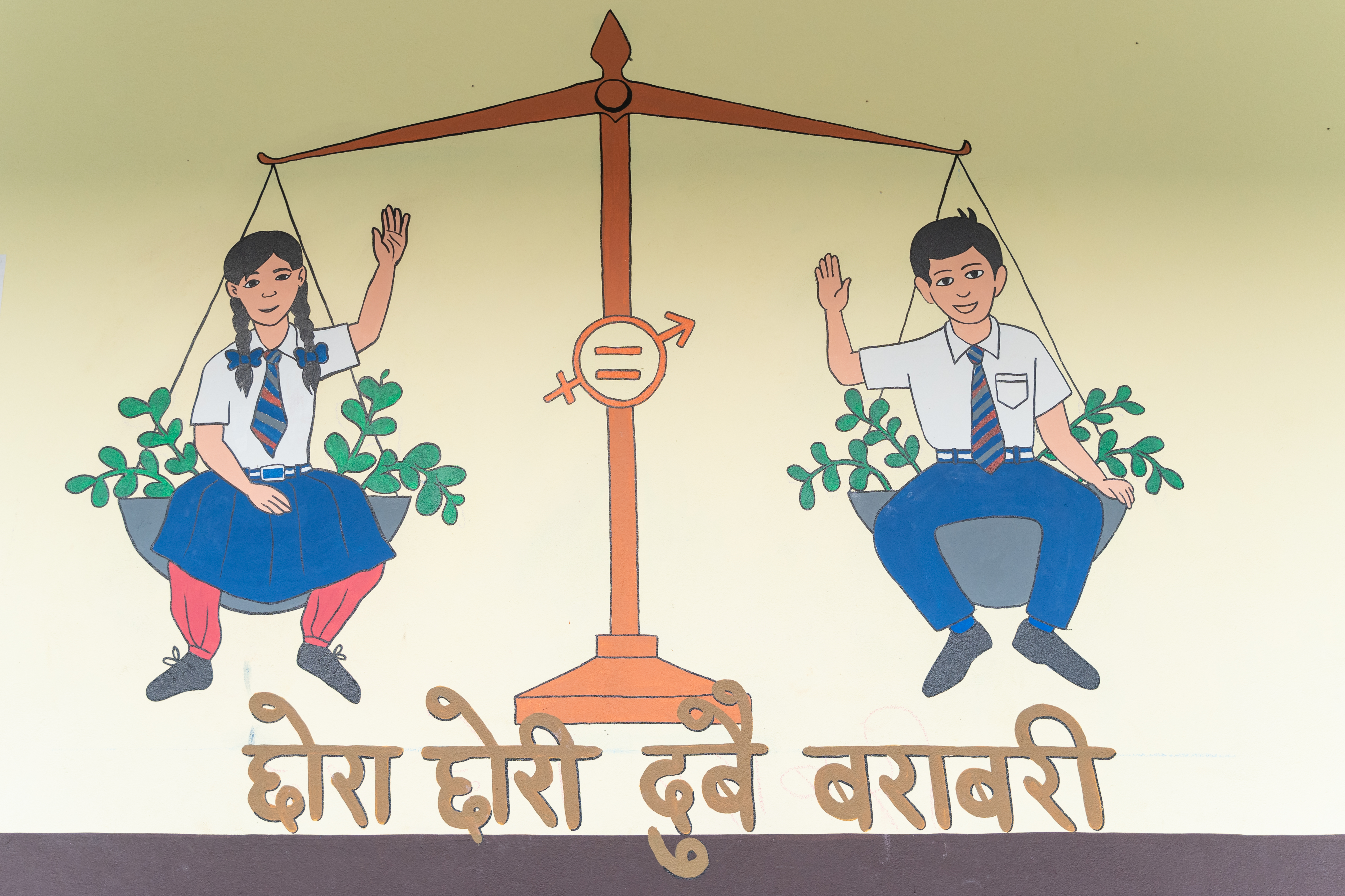 Mural in Nepal showing a girl and a boy in a set of scales. They are equal.