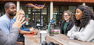 group of students chatting outside the Curve cafe
