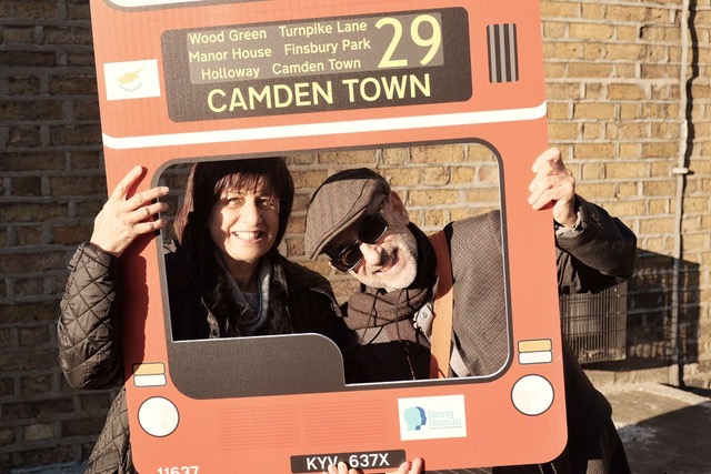 Two people with London bus cardboard cutout