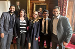 Karan Abhaykumar Parmar, Dr Maria Fanou, Daria Korniienko, Minul Muhamdiramge and João Gabriel Volasco Rodrigues standing in front of a panelled wall with portraits.