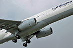 A commercial airplane taking off. It has the Lufthansa logo on the side.