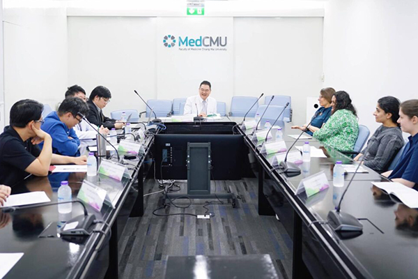 Photo of the programme team seated at tables during a workshop