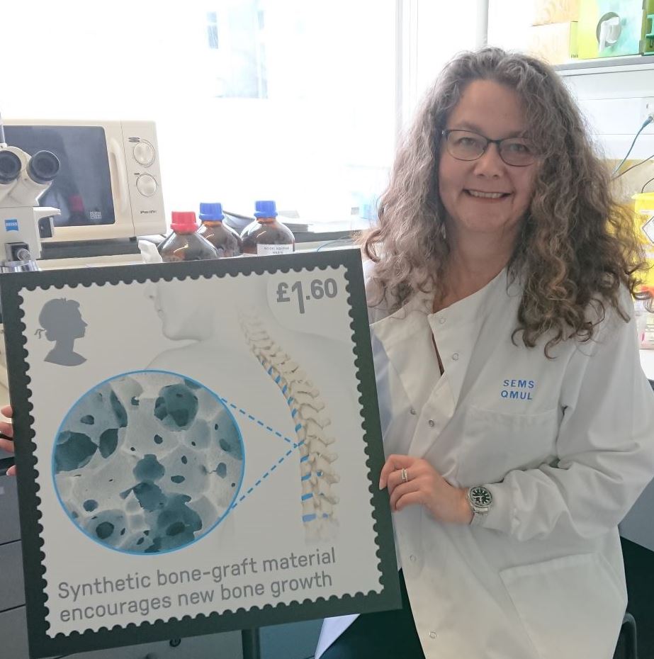 portrait of Dr Karin Hing with the Synthetic bone graft research stamp