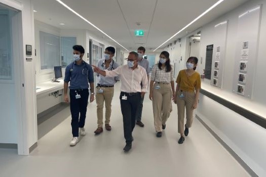 Doctor and students walking through hospital