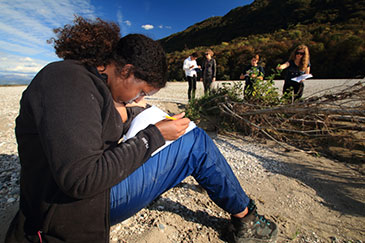 IMFE student Amina Sheikh-Osman taking notes on the Tagliamento field trip