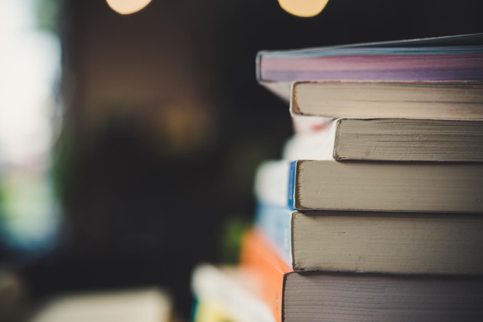 A photo of a pile of books against a background that is out of focus