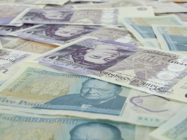 A photograph of several British banknotes