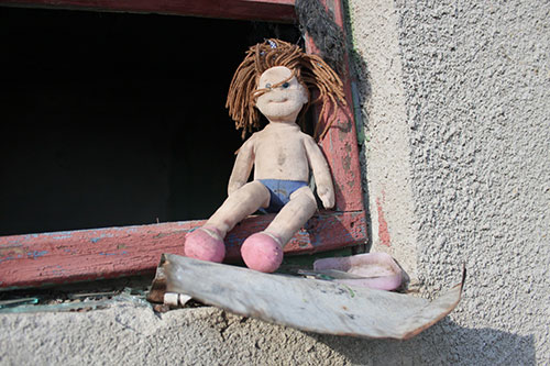 A disheveled doll laying on the street
