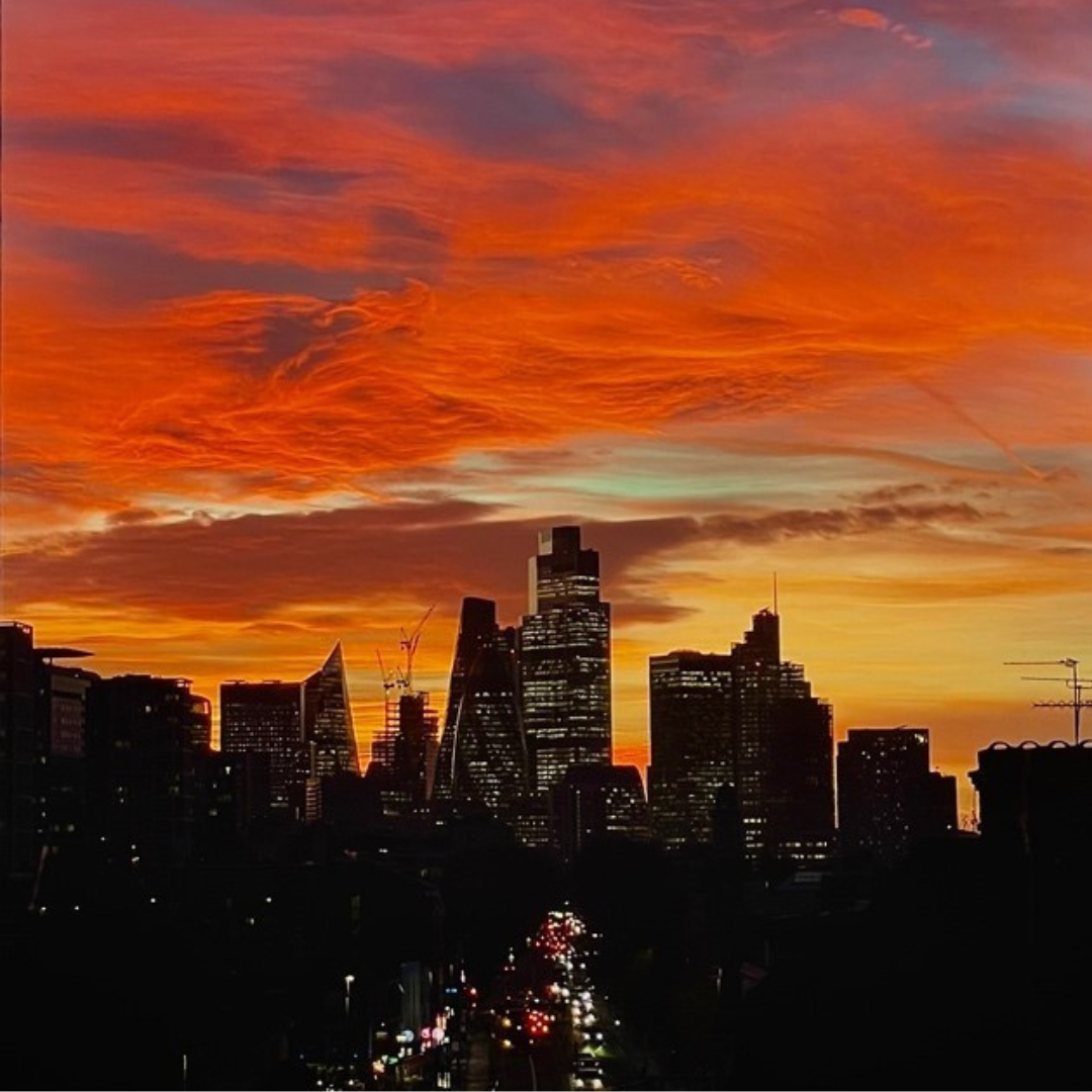 A yellow and red sunset over high rise buildings