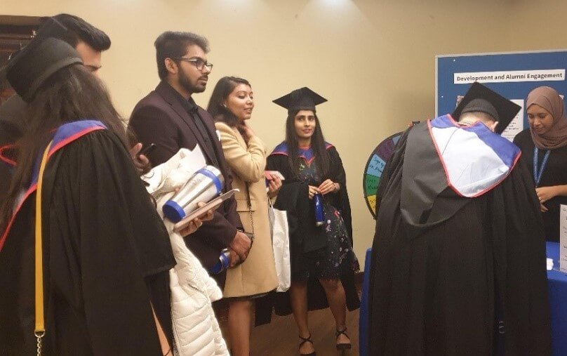 Students playing 'spin the wheel' game at graduation