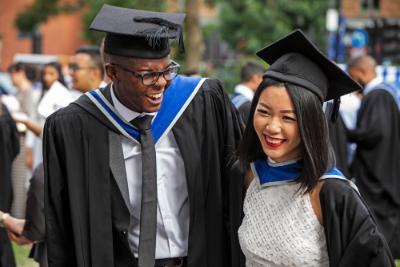 Two students smiling at their graduation