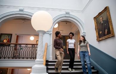 Students walking down Garrod Building staircase 