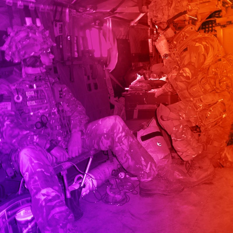 Armed forces medics inside a helicopter with bright coloured filter added