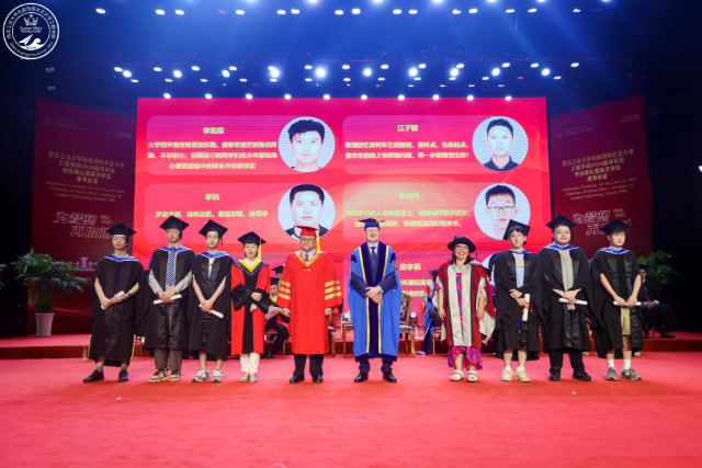 Principal Colin Bailey and Dr Maria Romero-Gonzalez, Executive Vice-Dean and Director of QMES, with graduates on stage at the 2024 NPU graduate ceremony