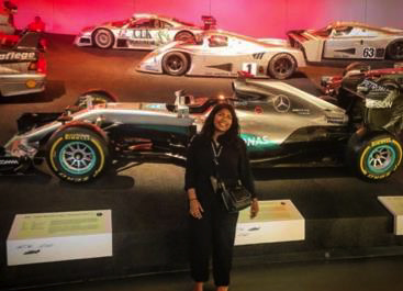 A student stands in front of a Mercedes F1