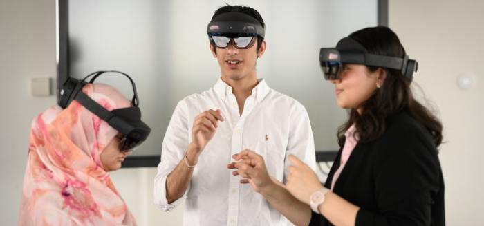 Three students using VR headsets