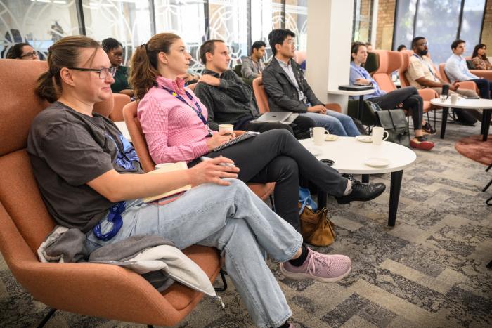 People sat in chairs, listening to a public speaker