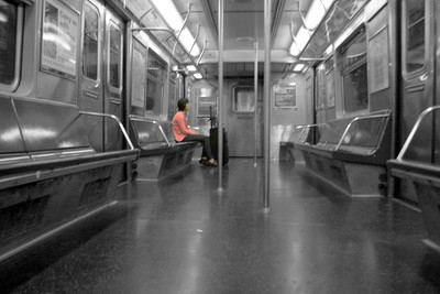 A person sitting on an underground train