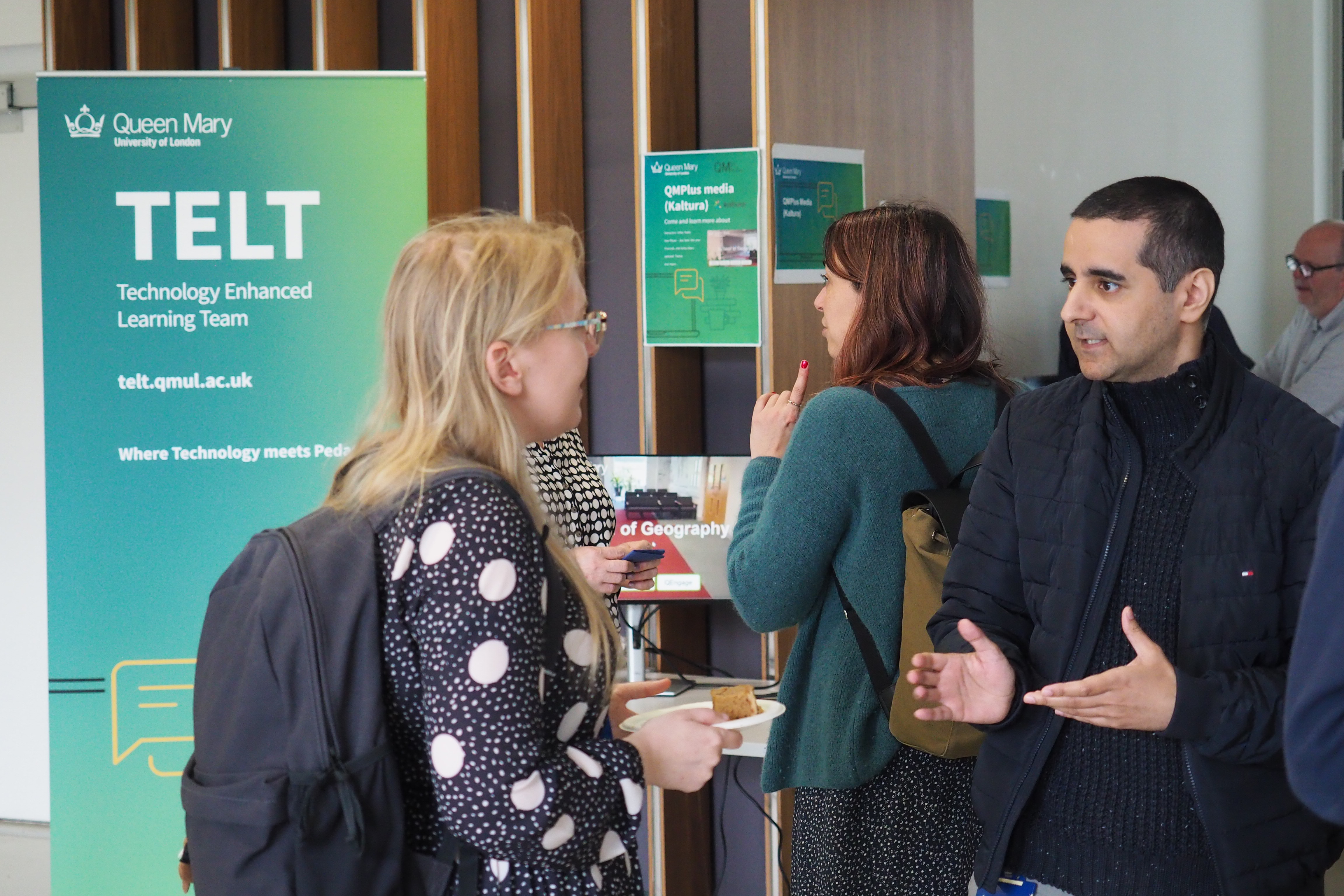 Two people engaged in conversation at a TELT event.