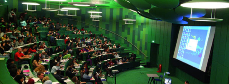 Side view of stage and audience in lecture hall in Whitechapel